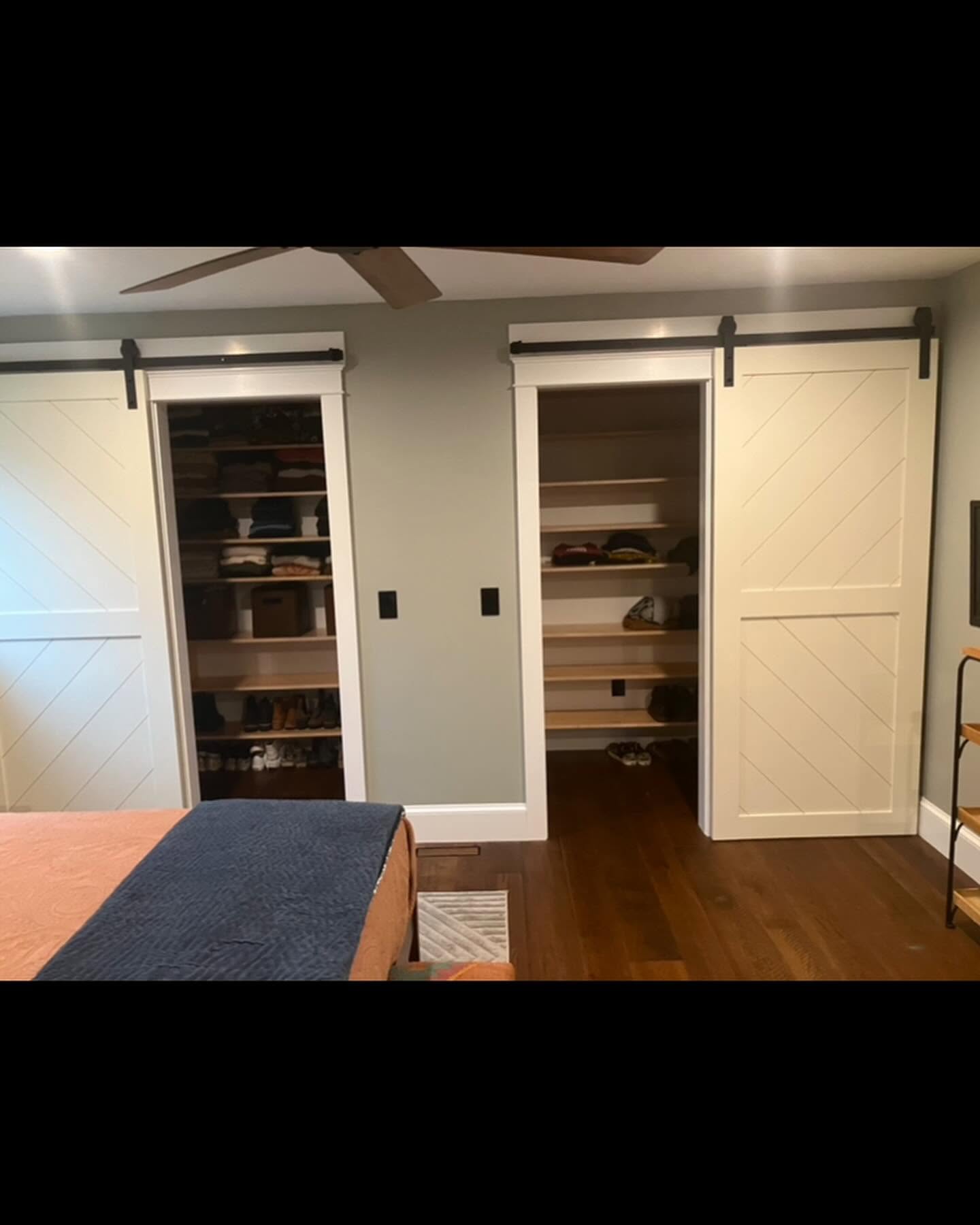 His and hers barn door closets in a primary bedroom