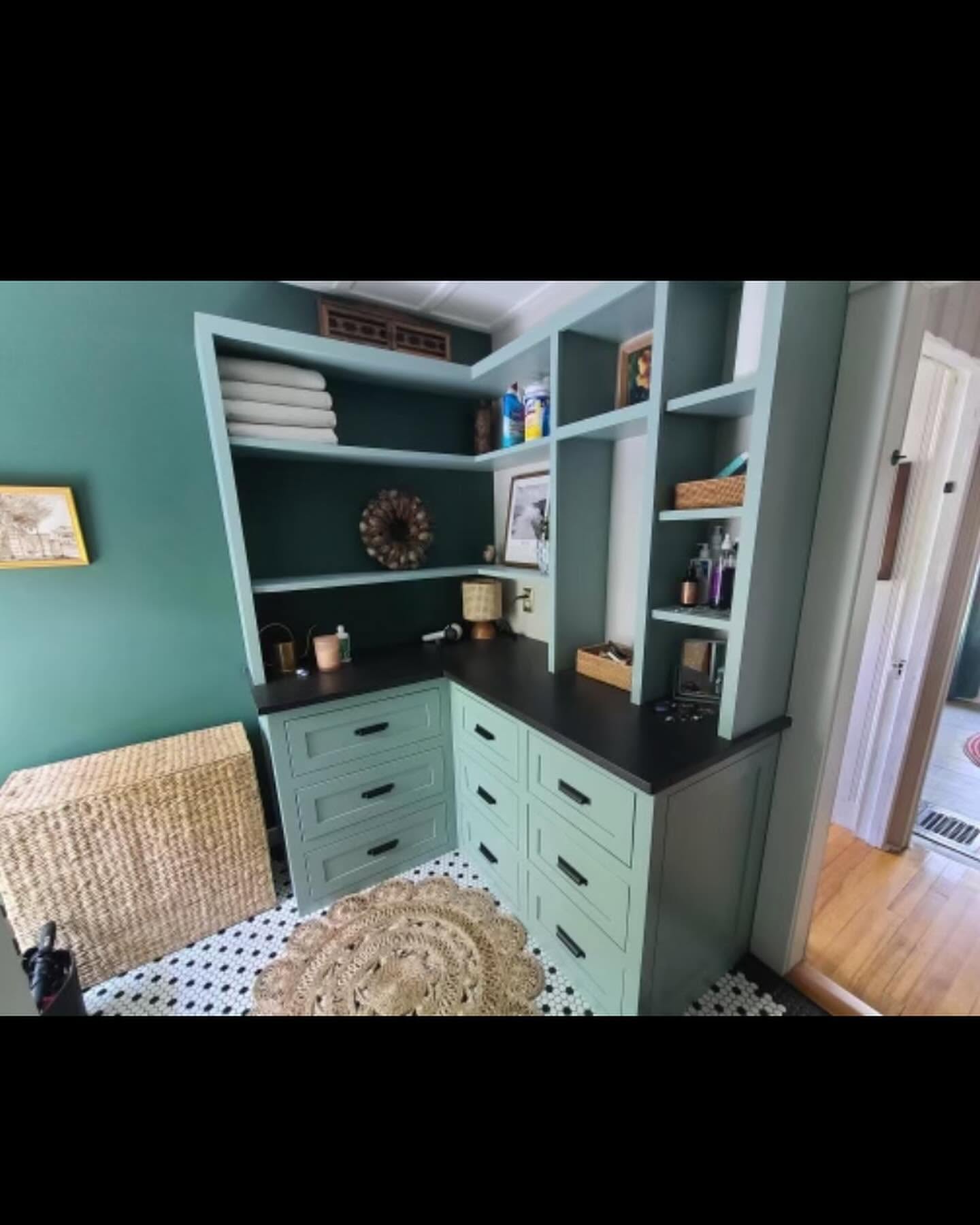 Built-in dressing nook with teal cabinetry